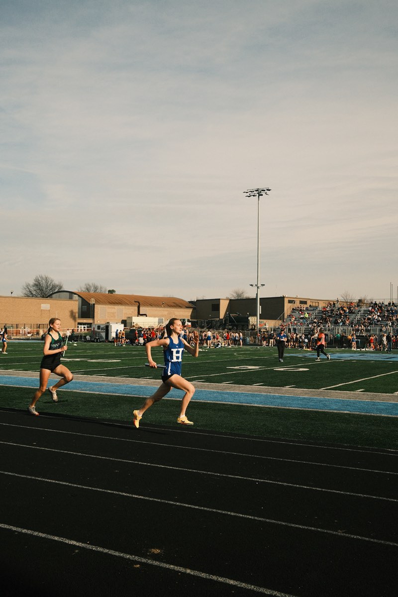Isla Meyn carrying the baton at the 2026 Boone County Opening Relays